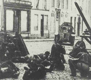 A German armored car attacks Belgian soldiers during street fighting in Charleroi.