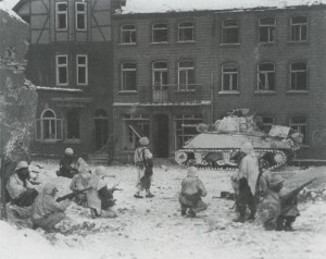 GIs from the 7th Armored Division take a watchful rest in the streets of St Vith