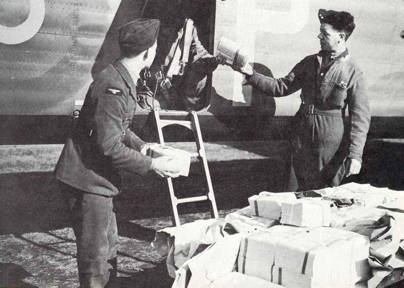 loading leaflets in a RAF bomber.