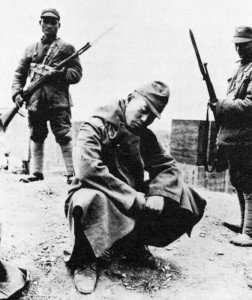 Japanese soldier with Chinese guards.