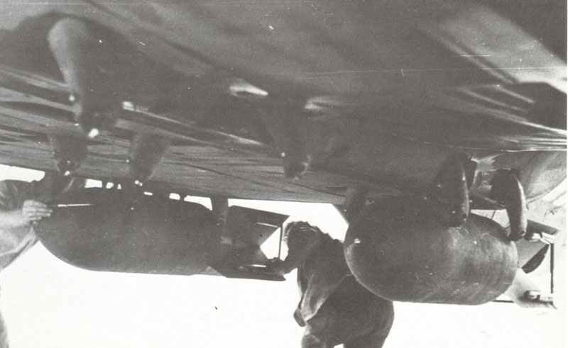 Loading SC-250 bombs on the external racks of an He 111