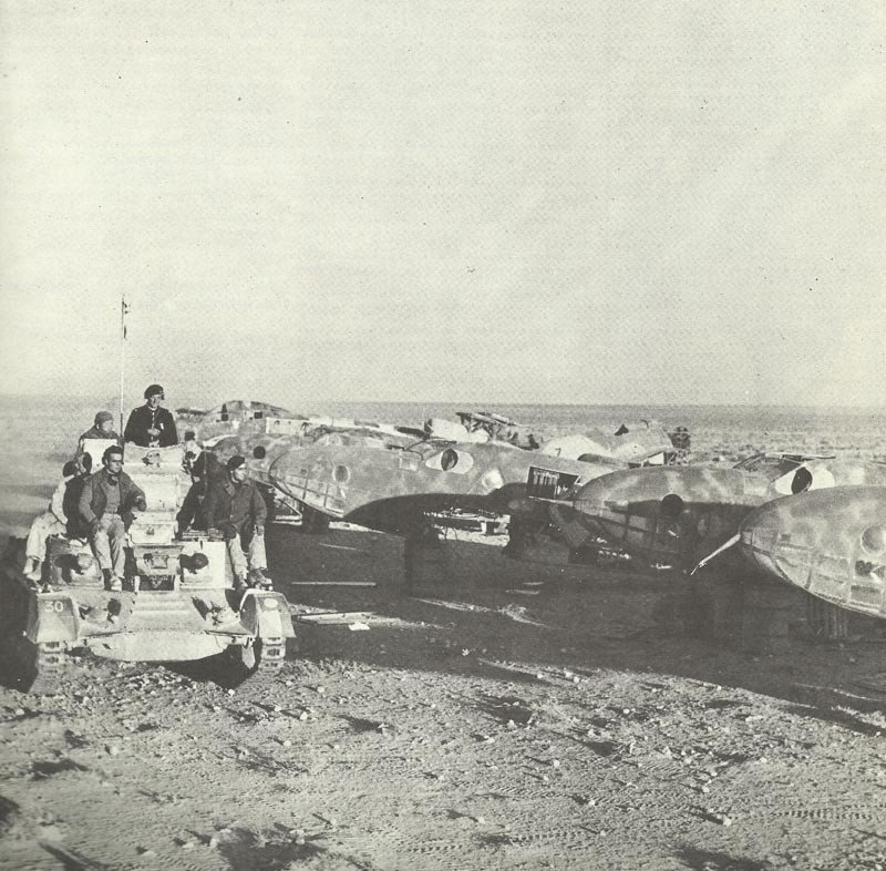 British tank passes destroyed Italian planes.