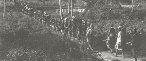 Local porters carry equipment