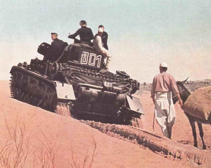 Panzer IV of the Afrika Korps is climbing a sand dune