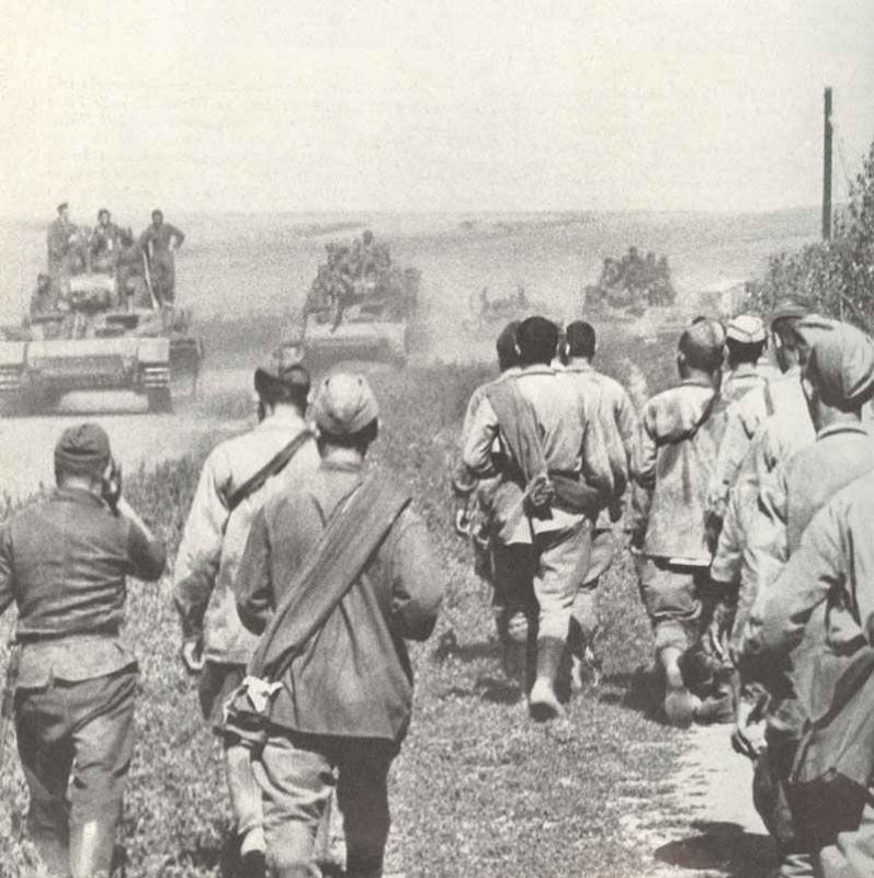 Russian prisoners walking backwards, German tanks advancing forward.