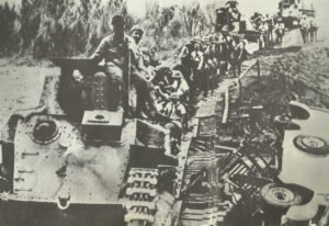 Japanese light tanks cross a provisional bridge