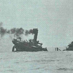 A torpedoed cargo ship sinks.