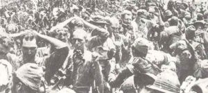 US prisoners pass their captors on Corregidor.