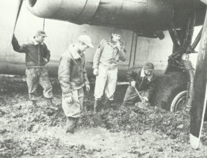 Trying to dig out a B-24 Liberator from mud