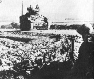 Stuart tank and British infantry in Tunisia.