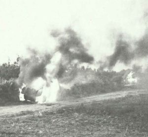 Italian armoured cars blazing on the road to Cap Bone. 