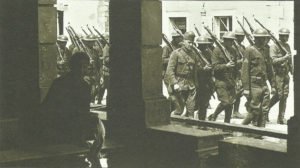 US troops march through a French village