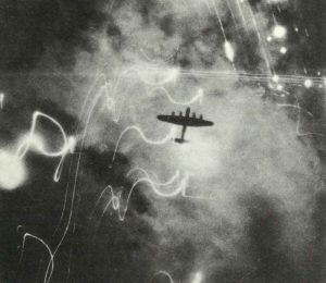 Lancaster bomber over the burning district of Altona in Hamburg