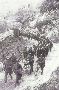 Italian troops advance across the Assiago plateau.