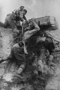 soldiers transport supplies across rough terrain