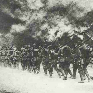 German infantry march through a burning French village