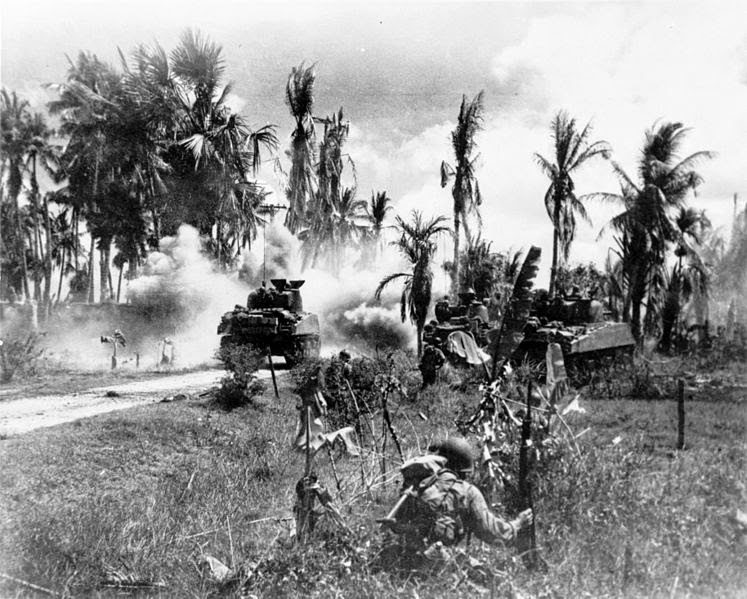 Sherman tanks with infantry advance from Lingayen Gulf